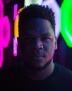 selective focus photography of man in black shirt thumbnail