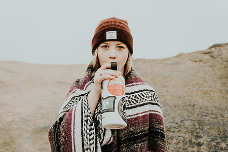 woman drinking on mountain thumbnail