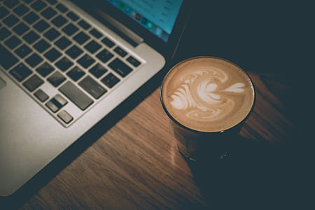 cappuccino near MacBook on table thumbnail