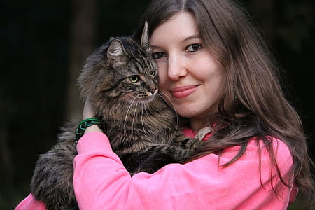woman hugging brown tabby cat thumbnail