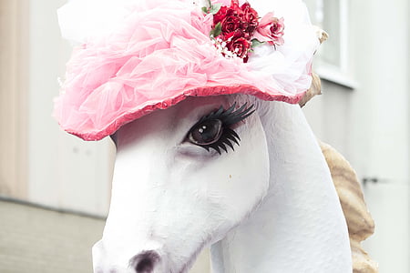 white horse statue with pink flower accent hat thumbnail