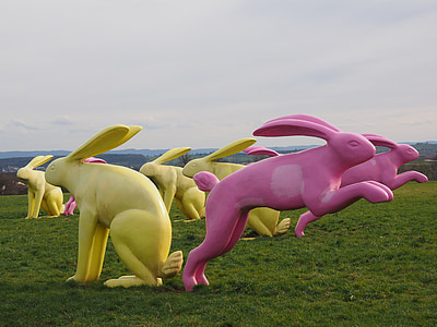 yellow and pink rabbit sculpture lot on grass field thumbnail