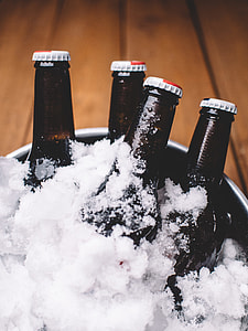 four black bottles on ice bucket thumbnail