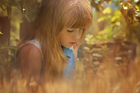 closeup photo of girl in blue and gray sleeveless top thumbnail