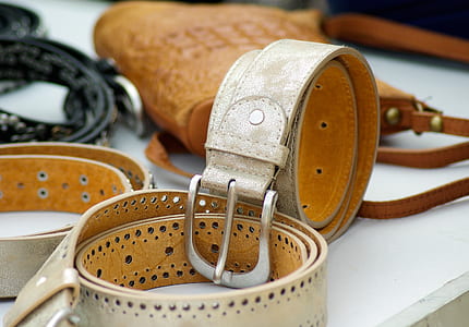 beige leather belt on white table thumbnail