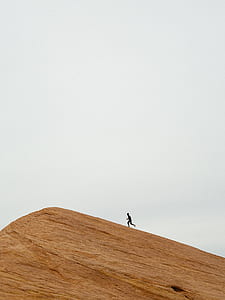 man running on top of hill during daytime thumbnail
