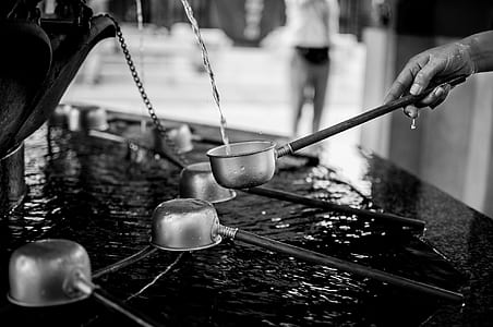 grayscale photography of person holding ladle thumbnail