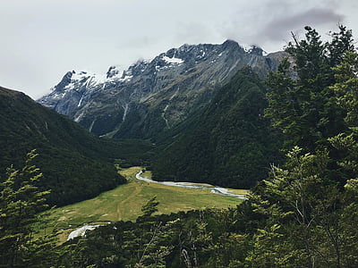 green mountain under cloudy sky thumbnail