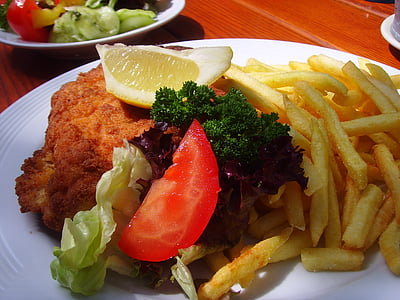 fried potatoes with meat and sliced lemon and tomato thumbnail
