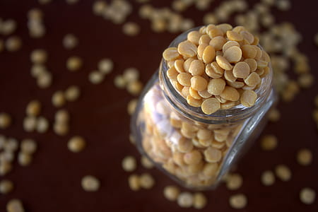 selective focus photo of brown seeds in glass bottle thumbnail