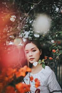 woman standing under green tree thumbnail