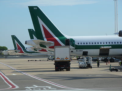 white-red-and-green airliner on gray concrete ground thumbnail