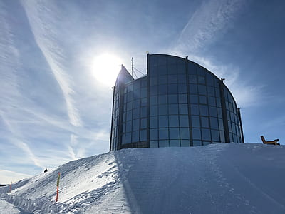building on snow-covered heel during daytime thumbnail