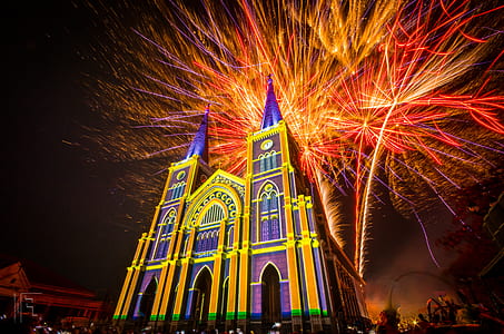 purple and yellow building with fireworks during nighttime thumbnail