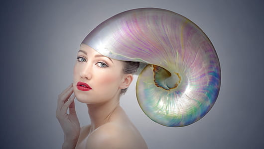 woman wearing iridescent snail hat thumbnail