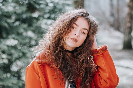 woman wearing orange coat thumbnail