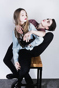 couple sitting on side table near wall thumbnail