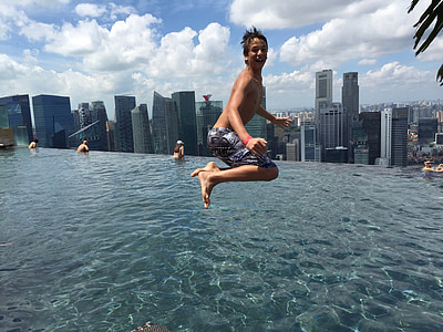 boy jumping on to infinity pool thumbnail
