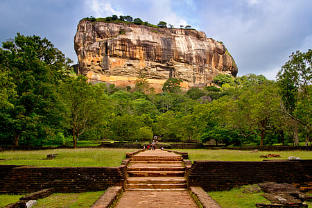high-range brown rock formation near trees during daytime thumbnail