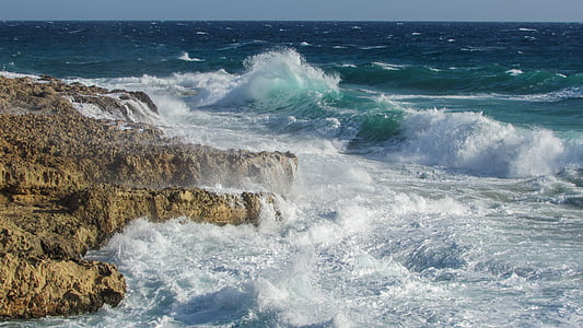 body of water and brown rock formations thumbnail