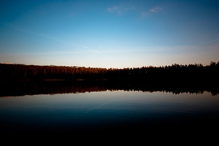 body of water surrounded with trees thumbnail