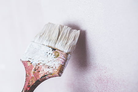 white paintbrush in front of wall thumbnail