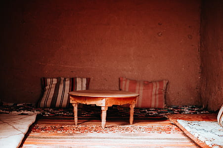 brown wooden coffee table near two pillows thumbnail