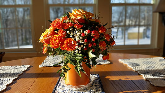 orange petaled flowers on vase arrangement thumbnail