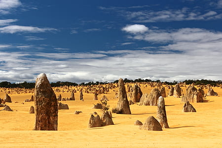 landscape photography of desert under blue sky and white clouds during daytime thumbnail