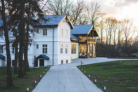 three storey building surrounded by trees under gray sky during daytime thumbnail