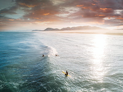 View of Three People Surfing thumbnail