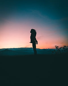 silhouette of standing woman during sunset thumbnail