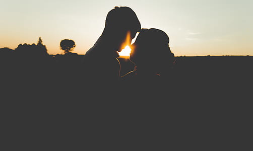 silhouette photo of man and woman attempting to kiss thumbnail