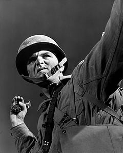 grayscale photo of soldier about to throw grenade with his left hand thumbnail