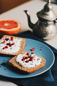 two breads with white cream and pomegranate seeds thumbnail