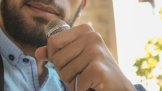 Close-up Photo of Man Holding Microphone thumbnail