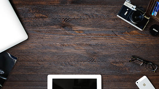 black and silver point-and-shoot camera on brown wooden surface thumbnail