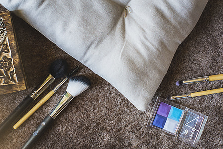 makeup brushes beside cushion thumbnail
