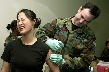 man injecting woman's houlder thumbnail