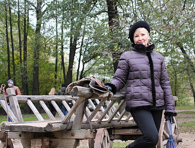 woman standing beside brown wooden trailer thumbnail