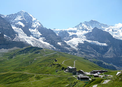 aerial photography residential area and snow capped mountain at daytime thumbnail