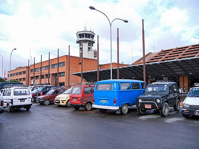 group of vehicle parks in front orange building thumbnail