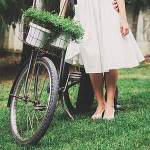 woman standing beside bicycle during daytime thumbnail