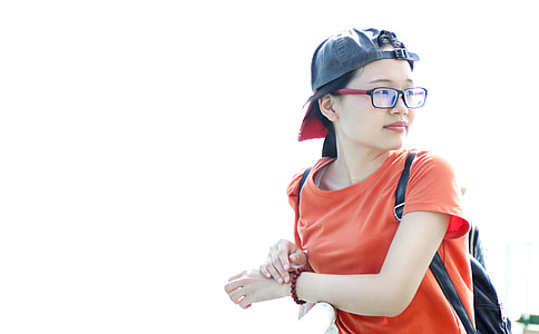 photo of girl wearing cap, eyeglasses and orange shirt thumbnail
