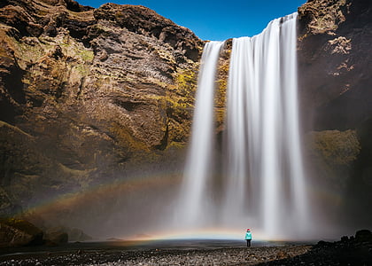 person standing near the waterfall thumbnail