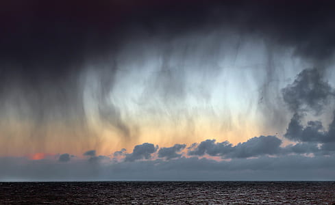 landscape photography of body of water and gray sky thumbnail