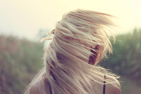 woman in black spaghetti-strap shirt whipping her hair thumbnail