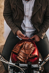 man sitting on red cruiser motorcycle thumbnail