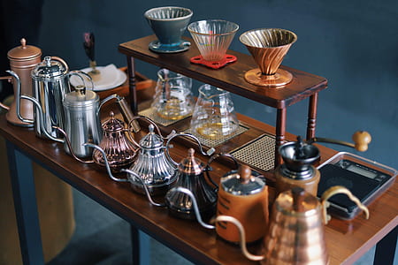 assorted teapots on brown wooden console table thumbnail