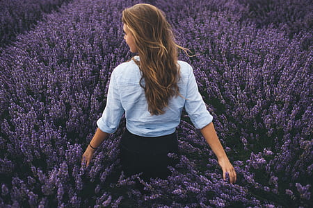standing woman surrounded by lavender flower during daytime thumbnail